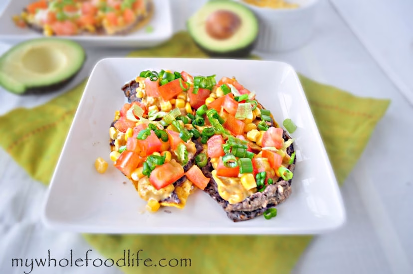 nachos topped with vegan cheese and veggies